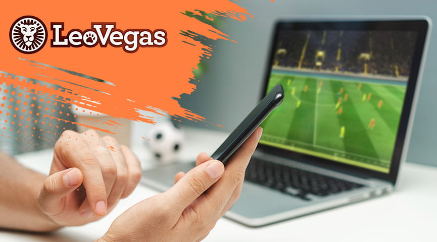 Dos apostantes realizan una apuesta desde sus smartphones con el logo de LeoVegas y una televisión con un partido de fútbol de fondo.